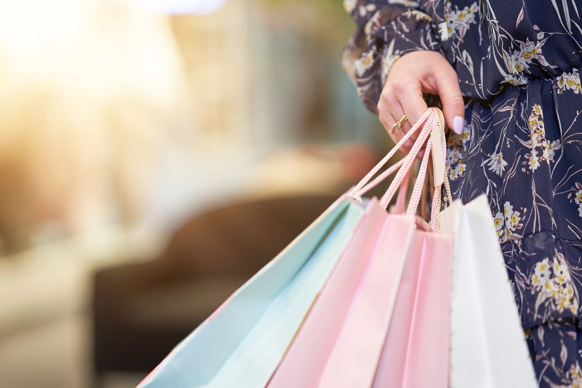 Happy woman shopping for clothes in store